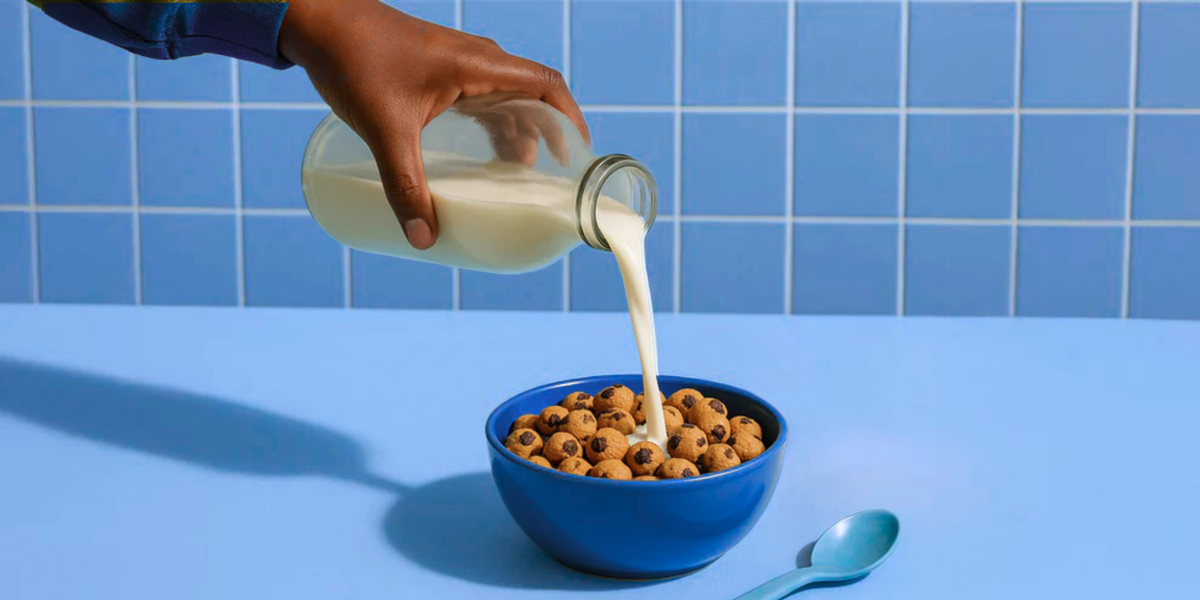 Mini chocolate chip cookies with milk in a blue bowl; no branded packaging